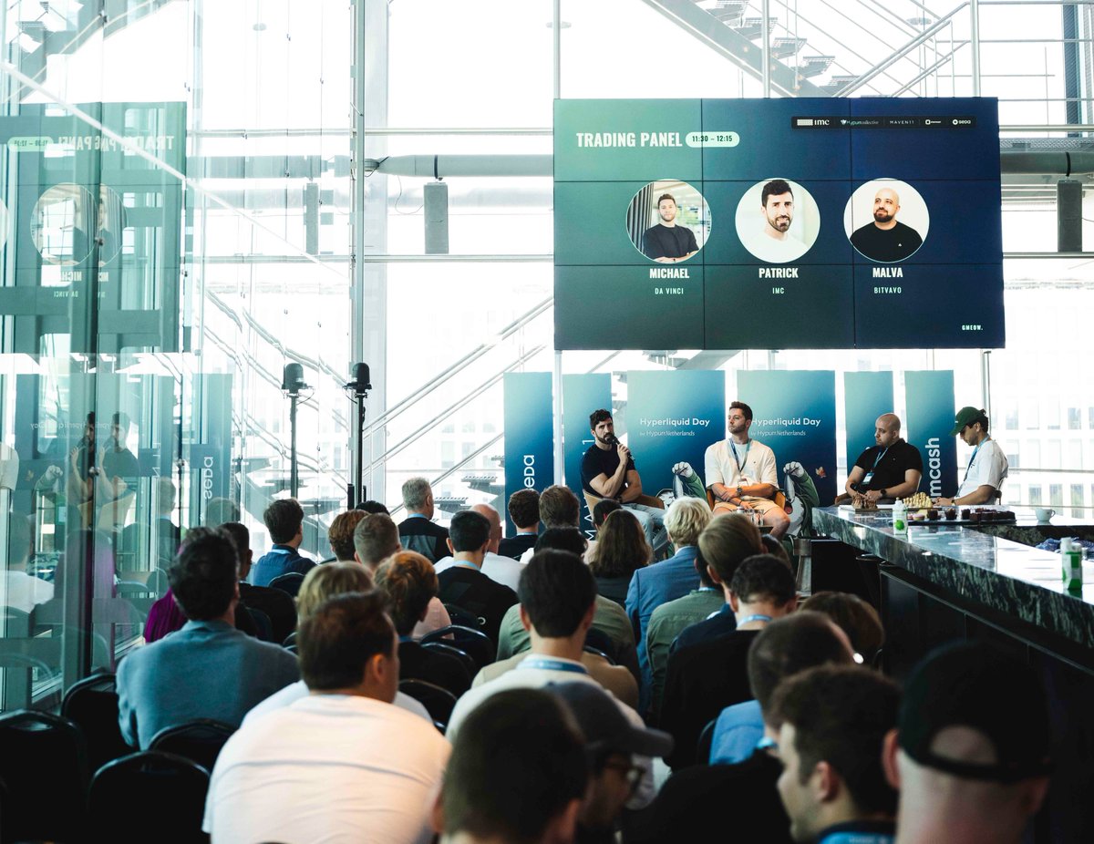 Trading panel on stage at a Hyperliquid Day event